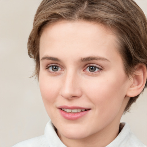 Joyful white young-adult female with medium  brown hair and green eyes