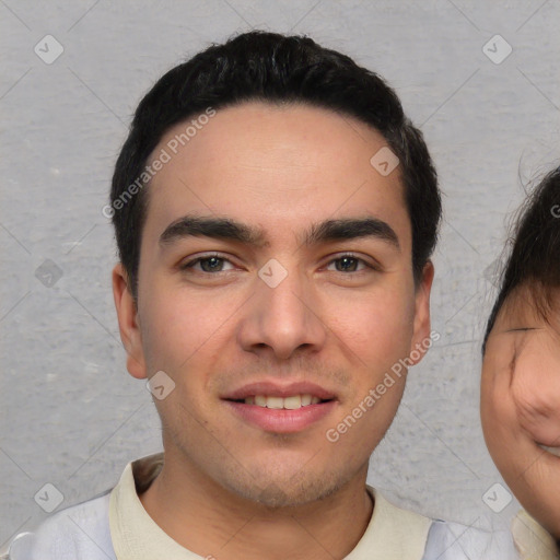 Joyful white young-adult male with short  black hair and brown eyes