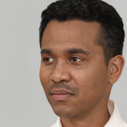 Neutral latino adult male with short  black hair and brown eyes