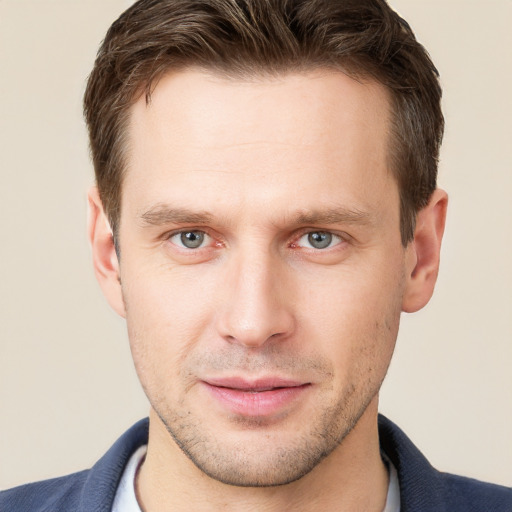 Joyful white young-adult male with short  brown hair and grey eyes