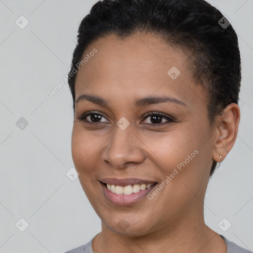 Joyful black young-adult female with short  brown hair and brown eyes