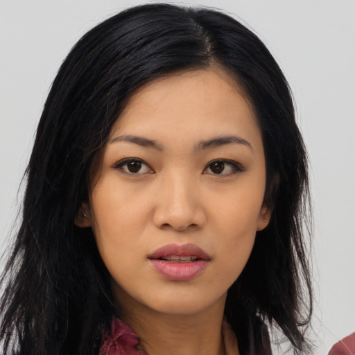Joyful asian young-adult female with long  black hair and brown eyes