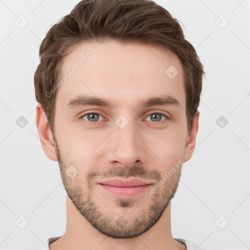 Joyful white young-adult male with short  brown hair and grey eyes