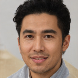 Joyful asian young-adult male with short  brown hair and brown eyes