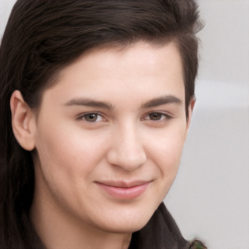 Joyful white young-adult male with long  brown hair and brown eyes