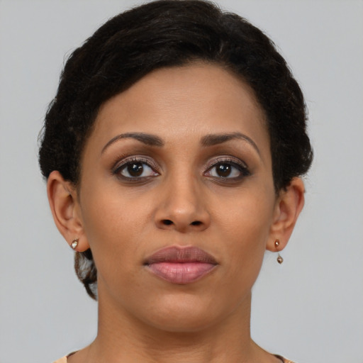 Joyful latino young-adult female with short  brown hair and brown eyes