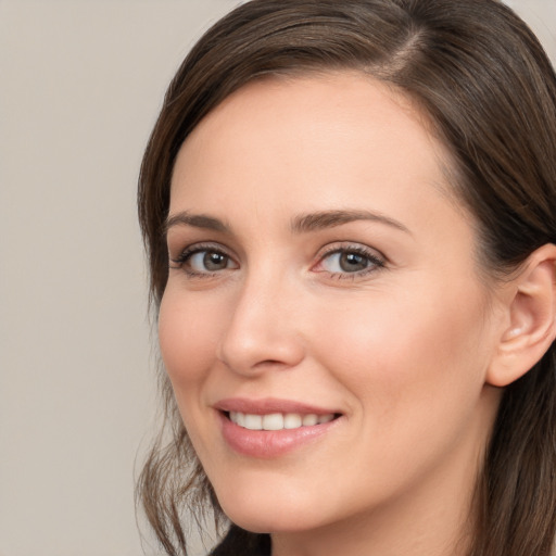 Joyful white young-adult female with medium  brown hair and brown eyes