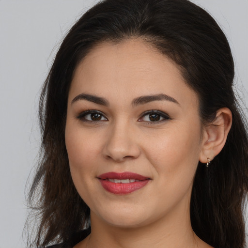 Joyful white young-adult female with long  brown hair and brown eyes