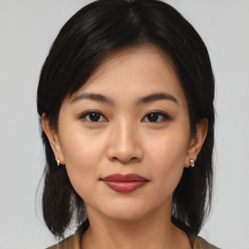 Joyful asian young-adult female with medium  black hair and brown eyes