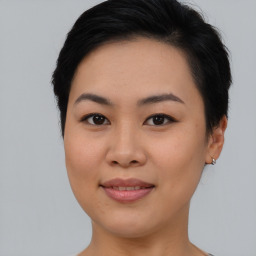 Joyful asian young-adult female with short  brown hair and brown eyes