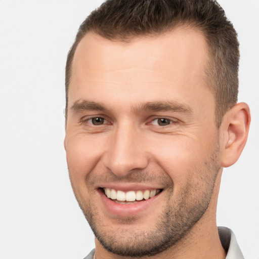 Joyful white young-adult male with short  brown hair and brown eyes