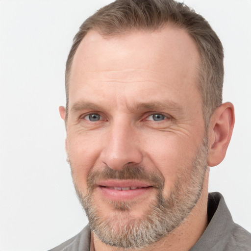 Joyful white adult male with short  brown hair and grey eyes