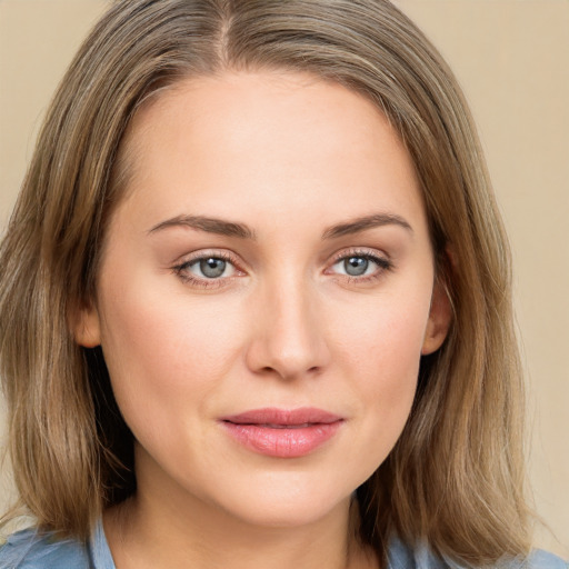 Joyful white young-adult female with medium  brown hair and blue eyes