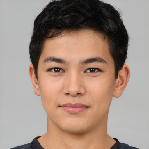 Joyful asian young-adult male with short  brown hair and brown eyes