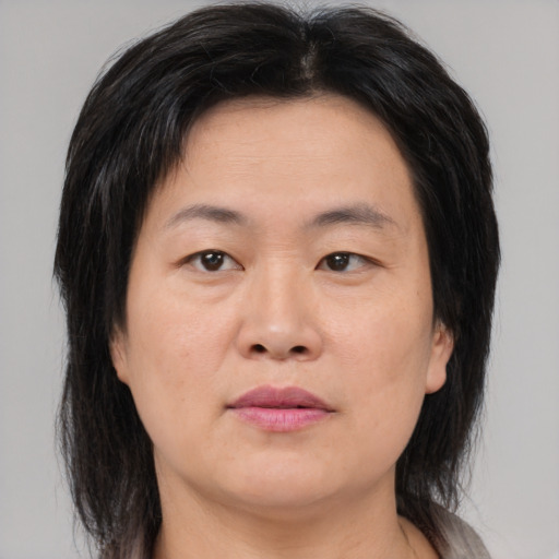 Joyful asian adult female with medium  brown hair and brown eyes