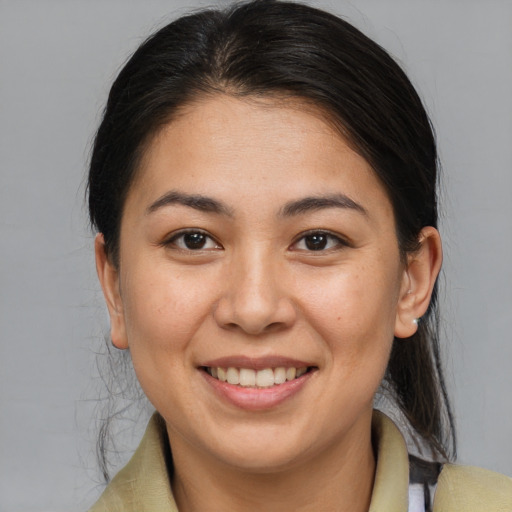 Joyful latino young-adult female with medium  brown hair and brown eyes