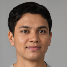 Joyful latino young-adult male with short  brown hair and brown eyes