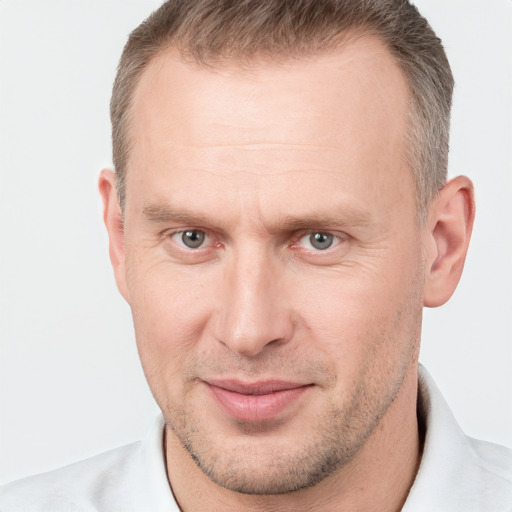 Joyful white adult male with short  brown hair and grey eyes