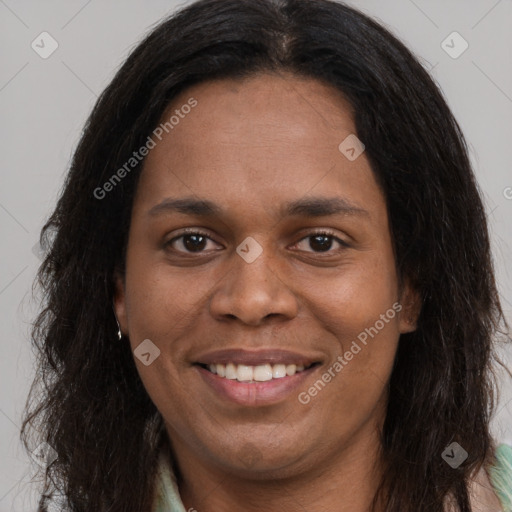 Joyful black young-adult female with long  brown hair and brown eyes