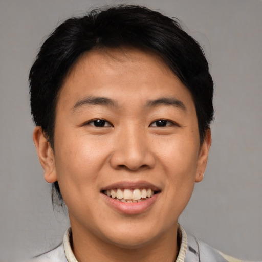 Joyful asian young-adult male with short  brown hair and brown eyes