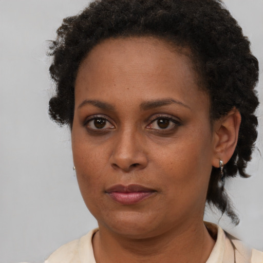 Neutral black adult female with short  brown hair and brown eyes