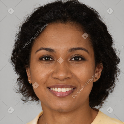 Joyful black young-adult female with long  brown hair and brown eyes