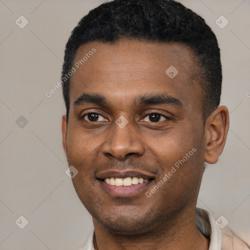 Joyful black young-adult male with short  black hair and brown eyes