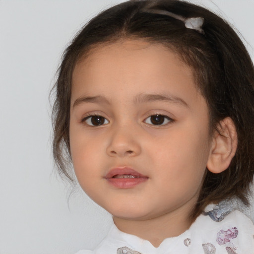 Joyful white child female with medium  brown hair and brown eyes