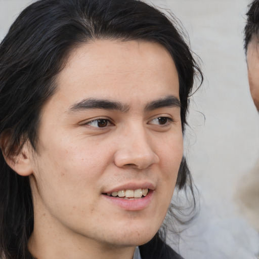 Joyful asian young-adult male with medium  black hair and brown eyes