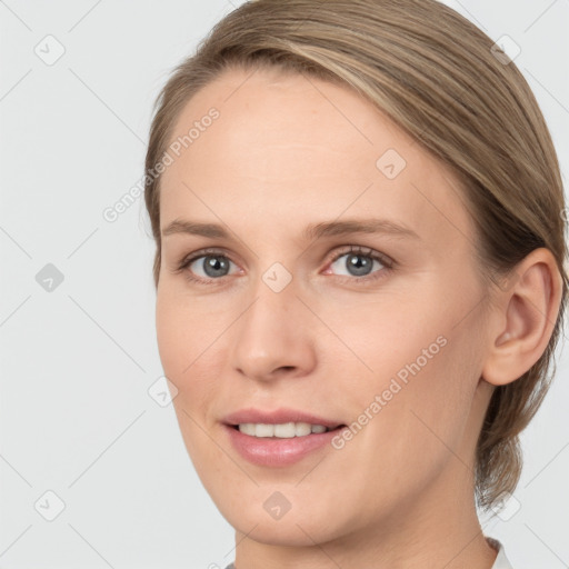 Joyful white young-adult female with medium  brown hair and blue eyes