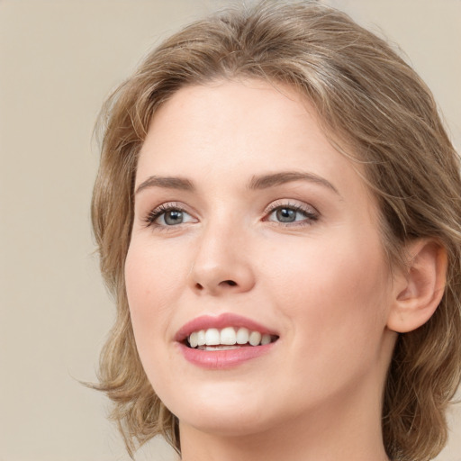 Joyful white young-adult female with medium  brown hair and green eyes