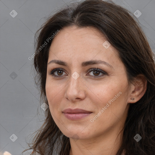 Joyful white adult female with long  brown hair and brown eyes