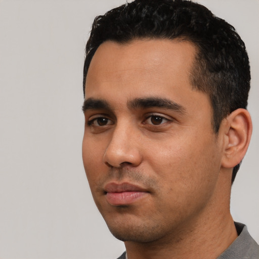 Neutral latino young-adult male with short  black hair and brown eyes