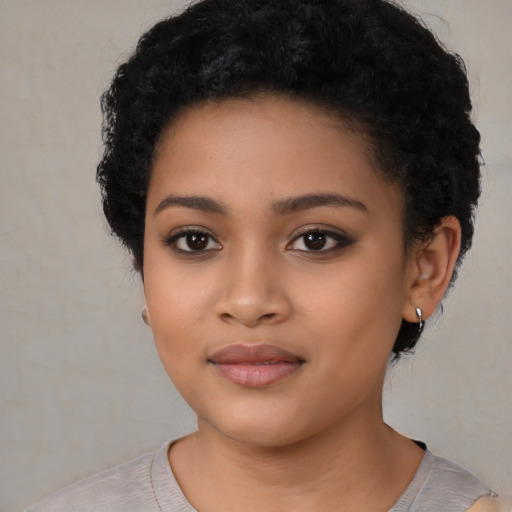 Joyful latino young-adult female with short  black hair and brown eyes