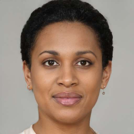 Joyful black young-adult female with short  brown hair and brown eyes