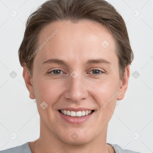 Joyful white young-adult female with short  brown hair and grey eyes