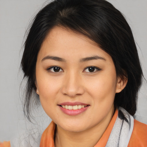 Joyful asian young-adult female with medium  brown hair and brown eyes