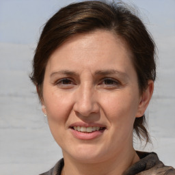 Joyful white adult female with medium  brown hair and brown eyes