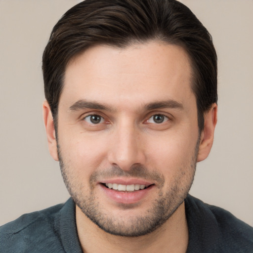 Joyful white young-adult male with short  brown hair and brown eyes