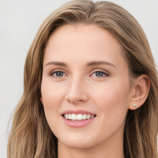 Joyful white young-adult female with long  brown hair and blue eyes