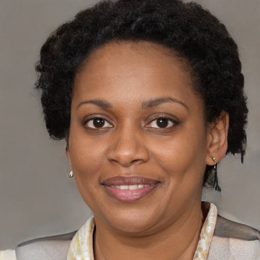 Joyful black adult female with short  brown hair and brown eyes