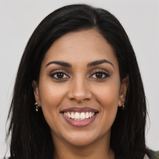 Joyful latino young-adult female with long  black hair and brown eyes