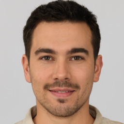 Joyful white young-adult male with short  brown hair and brown eyes