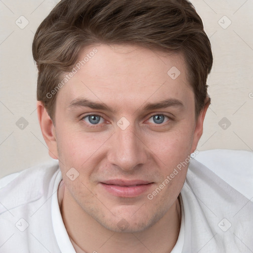 Joyful white young-adult male with short  brown hair and blue eyes