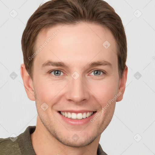 Joyful white young-adult male with short  brown hair and grey eyes