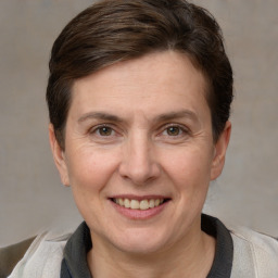 Joyful white adult female with short  brown hair and grey eyes