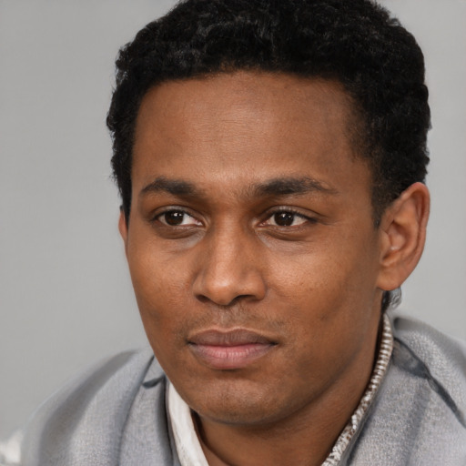 Neutral black adult male with short  black hair and brown eyes