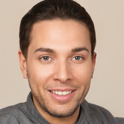 Joyful white young-adult male with short  brown hair and brown eyes