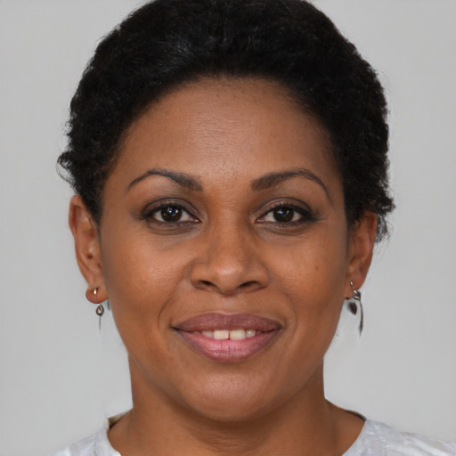 Joyful black adult female with short  brown hair and brown eyes