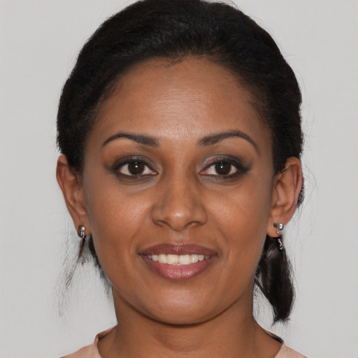 Joyful black young-adult female with medium  brown hair and brown eyes
